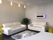 Waiting area in High Street Kensington, London W8 in stylish Cryotherapy centre with white sofas and treatment rooms available to rent