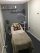 Beautiful treatment room in Hemel Hempstead aesthetic clinic with beauty bed & stylish grey decor