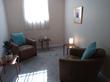 Bethnal Green Therapy Room to rent in London E2 with comfortable brown armchair, therapist chair & muted tones stylish decor, for talking therapy & psychotherapy