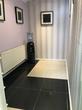 Beauty therapy room to rent in West Ealing Salon, unfurnished & empty with lilac purple walls & black and white tiled floor