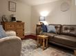Talking therapy room to rent in Fallowfield Manchester with comfy brown sofa and a beige colour scheme - For a therapist psychotherapist or counsellor