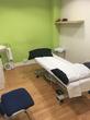Clinic Treatment room for hire in Pimplico near Victoria station, London, with massage table treatment couch & bright lime green wall