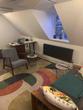 Brighton Therapy Room to rent in loft space with colourful rug, sofa, therapist chair & multicoloured fun youthful trendy decor