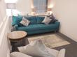EC4R Bank Talking Therapy Room for Hire in Central London with turquoise sofa & comfortable white armchair