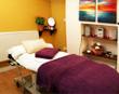 Beautiful Southampton Treatment room to rent in SO15 with massage table beauty couch, yellow walls & colourful wall art