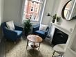 Beautiful London therapy room to rent in Bloomsbury, Holborn, near British Museum with armchairs, circular round mirror, modern interior deisgn & fireplace