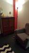 Liverpool Street Therapy Room for hire with therapist armchair & red decor accents, for a London counsellor or psychotherapist