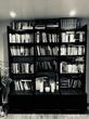 Black and white photo of a bookshelf, located in a therapist office that's available for hire in Oxford, UK