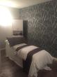 Beauty Treatment room for rent in Cobham KT11, with treatment massage table in Wellbeing & Beauty Salon, with modern dark charcoal grey floral wallpaper