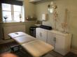 Therapy Room with treatment table, skeleton & spinal models for an osteopath physiotherapist massage therapist or bodywork