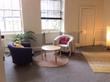 Bristol therapy room to rent in BS1 with armchairs, circular table & rug in room with lots of natural light from windows