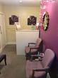 Reception area in Cheltenham Therapy Centre GL50 with purple walls & purple waiting area chairs