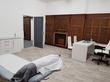 Large wood-paneled treatment room and consulting space to rent with consultation desk and massage table in Clinic in Newcastle upon tyne NE2